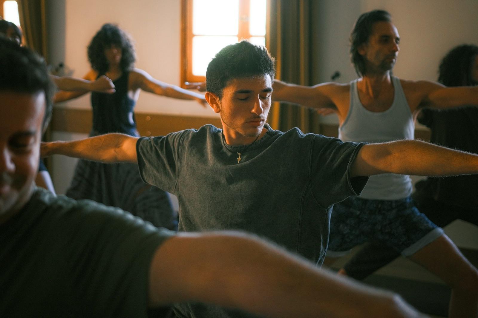 A yoga class in a warm, sunlit studio